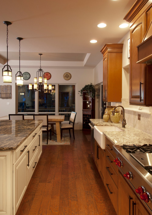 Golden Thunder and Santa Cecilia Granite Countertops on Ameretto Island and Saddle Base Cabinets.
